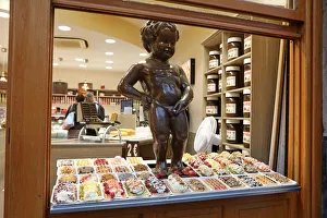Model of the Manneken Pis, statue of a boy peeing, in the window of a waffle shop in Model of the Manneken Pis, statue of a boy peeing, in the window of a waffle shop in