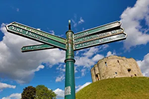 Tourist information signpost and Cliffords Tower at York Castle in York, Yorkshire Tourist information signpost and Cliffords Tower at York Castle in York, Yorkshire