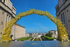 Yellow Arch of bicycles at the Mont des Arts Gardens and Tower of the Town Hall, Brussels Yellow Arch of bicycles at the Mont des Arts Gardens and Tower of the Town Hall, Brussels