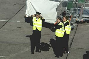 Images Dated 8th October 2005: Aer Arran flight crew protecting hearing whilst standing on tarmac at Cork Airport, Ireland