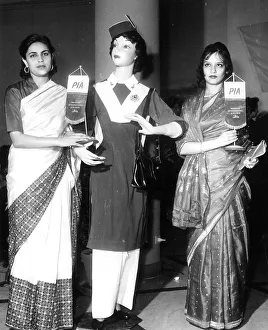 <b class=qtipBold><figcaption>Air Lovelies</figcaption></b><br>Posing besides a uniformed dummy, two lovely sari-wearing Pakistani airline hostesses are seen in Rome during a reception. Miss Hamida Parwin, and Mrs Chudary.<br><em>© Flightglobal</em> Air Lovelies