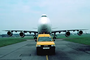 <b class=qtipBold><figcaption>Boeing 747 being guided</figcaption></b><br>B747 with airport car behind it Anisman<br><em>© Flight Global 2009 - All Rights Reserved</em> Boeing 747 being guided