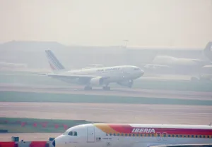 London Airport Arrivals Prints: Aircraft landing at Heathrow Airport, London Uk on a misty morning