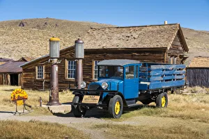 Abandoned blue old pickup truck and wooden deserted buildings in Bodie ghost town Abandoned blue old pickup truck and wooden deserted buildings in Bodie ghost town