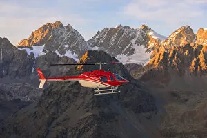 Aerial view of helicopter in flight on peaks of the Bernina Group, border of Italy