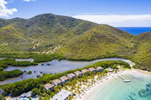 Aerial view of luxury resort on palm-fringed beach from above, Carlisle Bay, Antigua Aerial view of luxury resort on palm-fringed beach from above, Carlisle Bay, Antigua