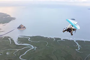 aerial view of Mont Saint Michel and Ultra light aircraft at high tide, Manche, France aerial view of Mont Saint Michel and Ultra light aircraft at high tide, Manche, France