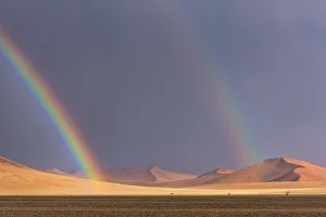 Africa, Namibia, Sossusvlei area. Thunderstorm with rainbows in the desert Africa, Namibia, Sossusvlei area. Thunderstorm with rainbows in the desert