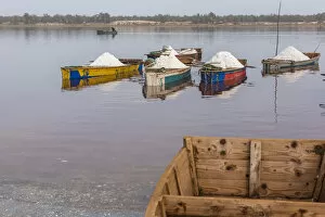 Africa, Senegal, Pink Lake. Salt collecting boats on shore of the lake