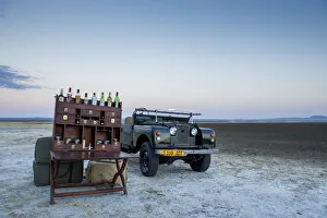 Ancient landrover and sundowner table on salt pan Ancient landrover and sundowner table on salt pan
