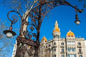 Art nouveau street lamp in Passeig de Gracia with Cases Antoni Rocamora building behind Art nouveau street lamp in Passeig de Gracia with Cases Antoni Rocamora building behind