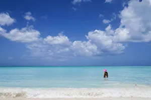 A bather with a pink hat in the turquoise waters of the Caribbean Sea The Nest Antigua A bather with a pink hat in the turquoise waters of the Caribbean Sea The Nest Antigua