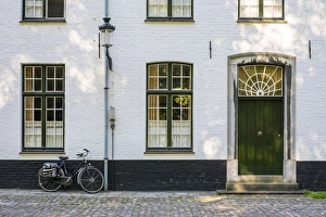Flemish BÚguinages Gallery: Belgium, West Flanders (Vlaanderen), Bruges (Brugge). Bicycle next to a house in the Begijnhof