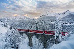 Bernina Express passes on a viaduct near Tarasp, Graubunden, Engadine, Switzerland Bernina Express passes on a viaduct near Tarasp, Graubunden, Engadine, Switzerland