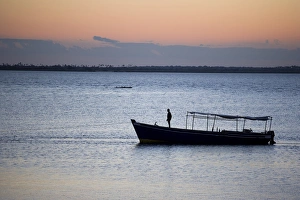A boat arrives at the Ilha do Mozambique at sunset A boat arrives at the Ilha do Mozambique at sunset