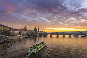 Boat going towards Charles Bridge and Church of Saint Francis of Assisi with Old Town Boat going towards Charles Bridge and Church of Saint Francis of Assisi with Old Town