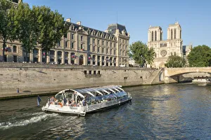 Boat tour along the banks of the Seine with cathedral Notre Dame in the background Boat tour along the banks of the Seine with cathedral Notre Dame in the background