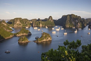 Boats anchored at Ti Top surrounded by karst mountains, Halong Bay, Quang Ninh Province Boats anchored at Ti Top surrounded by karst mountains, Halong Bay, Quang Ninh Province