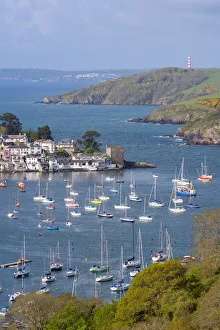 Boats moored in the sheltered waters of Fowey Estuary near Polruan, Cornwall, England Boats moored in the sheltered waters of Fowey Estuary near Polruan, Cornwall, England