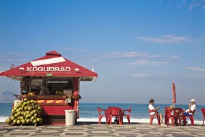 Brazil, Rio De Janeiro, Ipanema Beach, People drinking coconut juice at Kiosk Brazil, Rio De Janeiro, Ipanema Beach, People drinking coconut juice at Kiosk