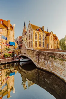 Bruges old city reflecting in the water canal at sunrise, Belgium Bruges old city reflecting in the water canal at sunrise, Belgium