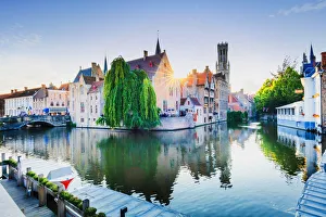Bruges old town reflecting in the water canal at sunset, Belgium Bruges old town reflecting in the water canal at sunset, Belgium