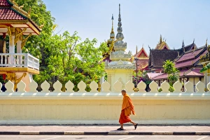 A buddhist monk walks past Wat Si Saket (Wat Sisaket) temple in central Vientiane, Laos A buddhist monk walks past Wat Si Saket (Wat Sisaket) temple in central Vientiane, Laos