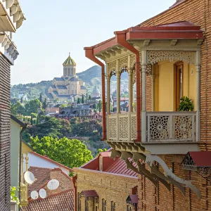 Buildings in old town Abanotubani bath district with Holy Trinity Cathedral in background Buildings in old town Abanotubani bath district with Holy Trinity Cathedral in background