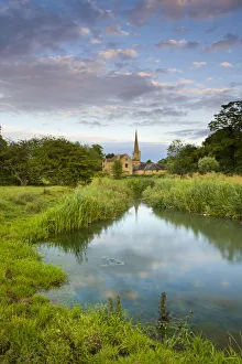 Burford Church spire reflected in the River Windrush watermeadows, Burford, The Cotswolds Burford Church spire reflected in the River Windrush watermeadows, Burford, The Cotswolds