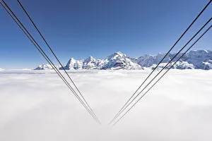 Cableway hidden by fog with Eiger, Monch and Jungfrau, Murren Birg, Berner Oberland, Switzerland Cableway hidden by fog with Eiger, Monch and Jungfrau, Murren Birg, Berner Oberland, Switzerland