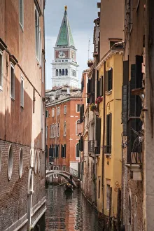 Campanile and gondola on canal in Venice, Italy Campanile and gondola on canal in Venice, Italy