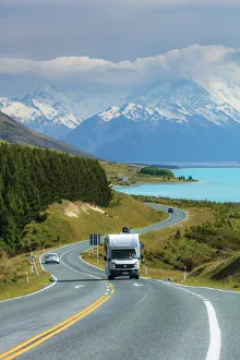 A camper driving along the highway running near Pukaki lake with Mount Cook (Aoraki A camper driving along the highway running near Pukaki lake with Mount Cook (Aoraki