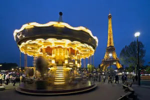 Carousel below the Eiffel Tower at twilight, Paris France Carousel below the Eiffel Tower at twilight, Paris France