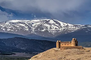 Castillo de la Calahorra castle with the Sierra Nevada mountain range in the background Castillo de la Calahorra castle with the Sierra Nevada mountain range in the background