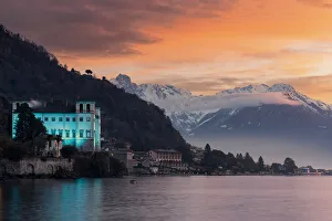 Charming old building Palazzo Gallio and snowy peaks at sunrise during Christmas time Charming old building Palazzo Gallio and snowy peaks at sunrise during Christmas time