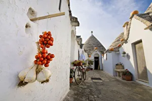 Classic Italian foreshortening in Alberobello, with Trulli, Garlic and Cherry tomatoes Classic Italian foreshortening in Alberobello, with Trulli, Garlic and Cherry tomatoes