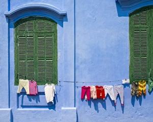 Clothes hung out to dry on a blue wall, Hoi An, Quang Nam Province, Vietnam Clothes hung out to dry on a blue wall, Hoi An, Quang Nam Province, Vietnam