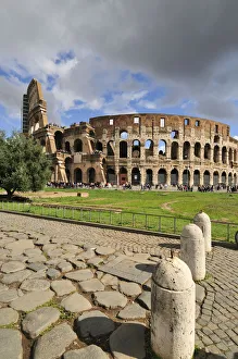 The Colosseum or Coliseum and a roman stone pavement on the foreground The Colosseum or Coliseum and a roman stone pavement on the foreground