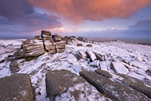 Colourful sunrise above snow covered moorland, Belstone Tor, Dartmoor, Devon, England Colourful sunrise above snow covered moorland, Belstone Tor, Dartmoor, Devon, England