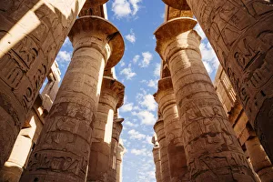 Columns and blue sky at Great hypostyle hall in the Precinct of Amun Re - Karnak Temple Columns and blue sky at Great hypostyle hall in the Precinct of Amun Re - Karnak Temple