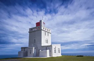 Sudurland Region Gallery: Concrete Dyrholaey Lighthouse against cloudy sky at Dyrholaey, South Iceland, Iceland