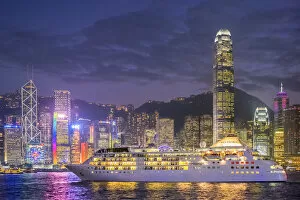 Cruise Ship Collection: Cruisliner Silversea passing by Hong Kong Island skyline on Victoria Harbor at night