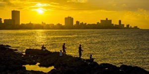 Cuba, Havana, The Malecon, Man fishing Cuba, Havana, The Malecon, Man fishing