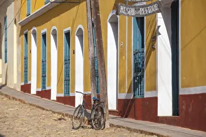 Cuba, Trinidad, Bike leaning against lamp post by colourful houses Cuba, Trinidad, Bike leaning against lamp post by colourful houses