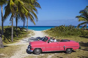 Cuba, Varadero, Pink Plymouth car on Varadero beach Cuba, Varadero, Pink Plymouth car on Varadero beach