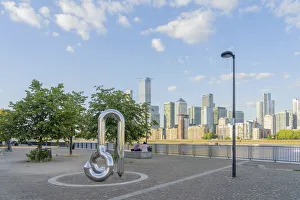 Curlicue sculpture by William Pye and Canary Wharf and the River Thames, London,England Curlicue sculpture by William Pye and Canary Wharf and the River Thames, London,England