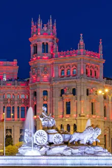Cybele Palace or Palacio de Cibeles city hall illuminated by colors of Spanish flag Cybele Palace or Palacio de Cibeles city hall illuminated by colors of Spanish flag