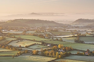 Dawn view over misty Somerset Levels countryside towards Glastonbury Tor, Somerset Dawn view over misty Somerset Levels countryside towards Glastonbury Tor, Somerset