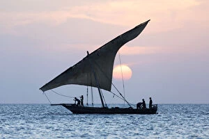 Stone Town of Zanzibar Gallery: A dhow sails in front of the setting sun, Stone Tpwn, Zanzibar, Tanzania