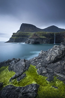 Dramatic coastline and waterfall at Gasadalur on the Island of Vagar, Faroe Islands Dramatic coastline and waterfall at Gasadalur on the Island of Vagar, Faroe Islands